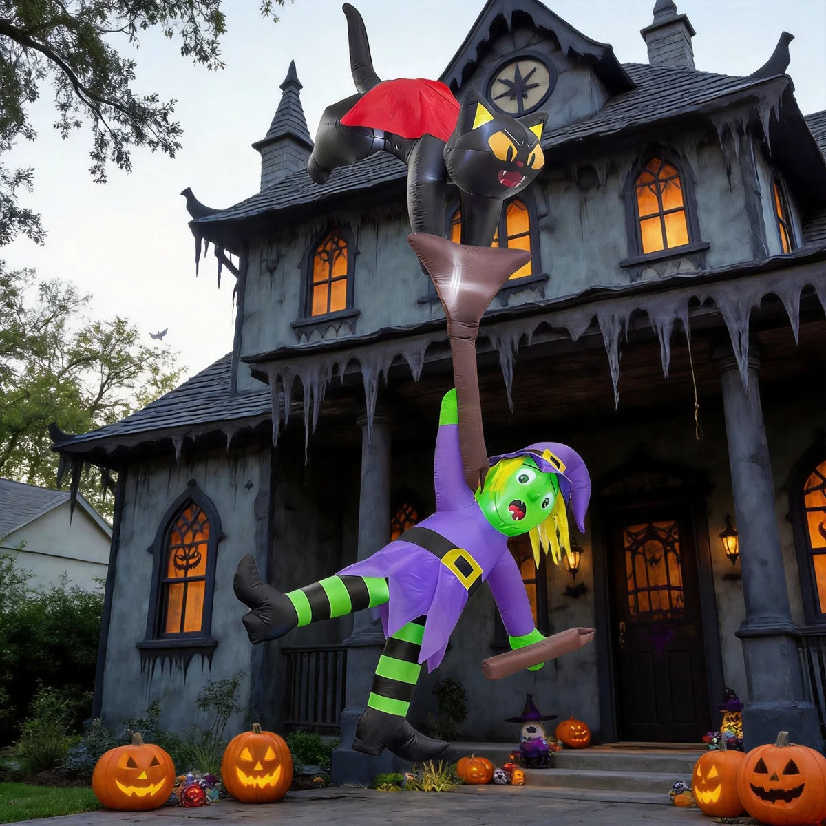 House decorated for Halloween at night with a giant inflatable