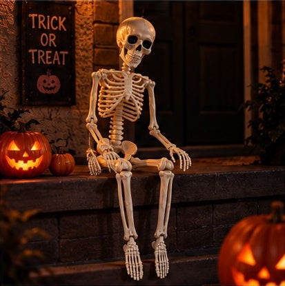 Posable skeleton sitting on a porch step next to a Trick or Treat sign