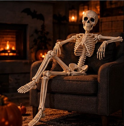 Posable skeleton lounging on a sofa by the fireplace